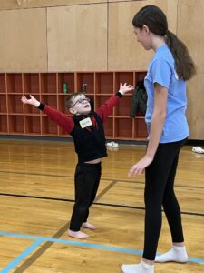 A young Creativity Club boy dancing with a Hot Shots coach